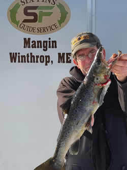 Man holding a Salmon he caught.