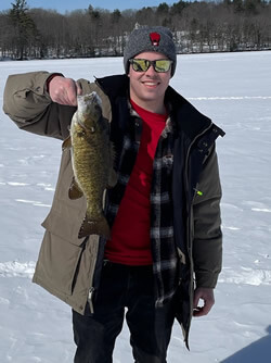 Smiling man holding his Smallmouth Bass.