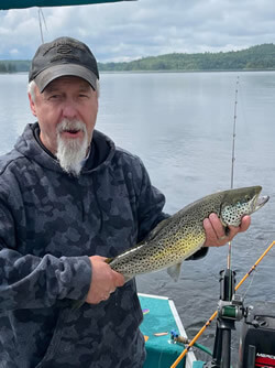 Man holding a Brown Trout he caught.