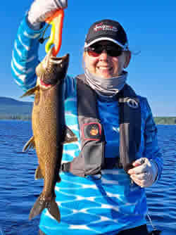 Woman holding a lake trout.