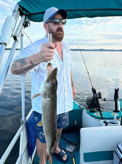 Man holding a Northern Pike he caught.