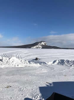 Frozen Moosehead Lake with Mt. Kineo in the background.